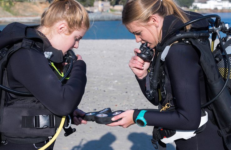 Scuba divers performing a pre-dive safety check