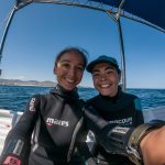 smilling divers on a boats